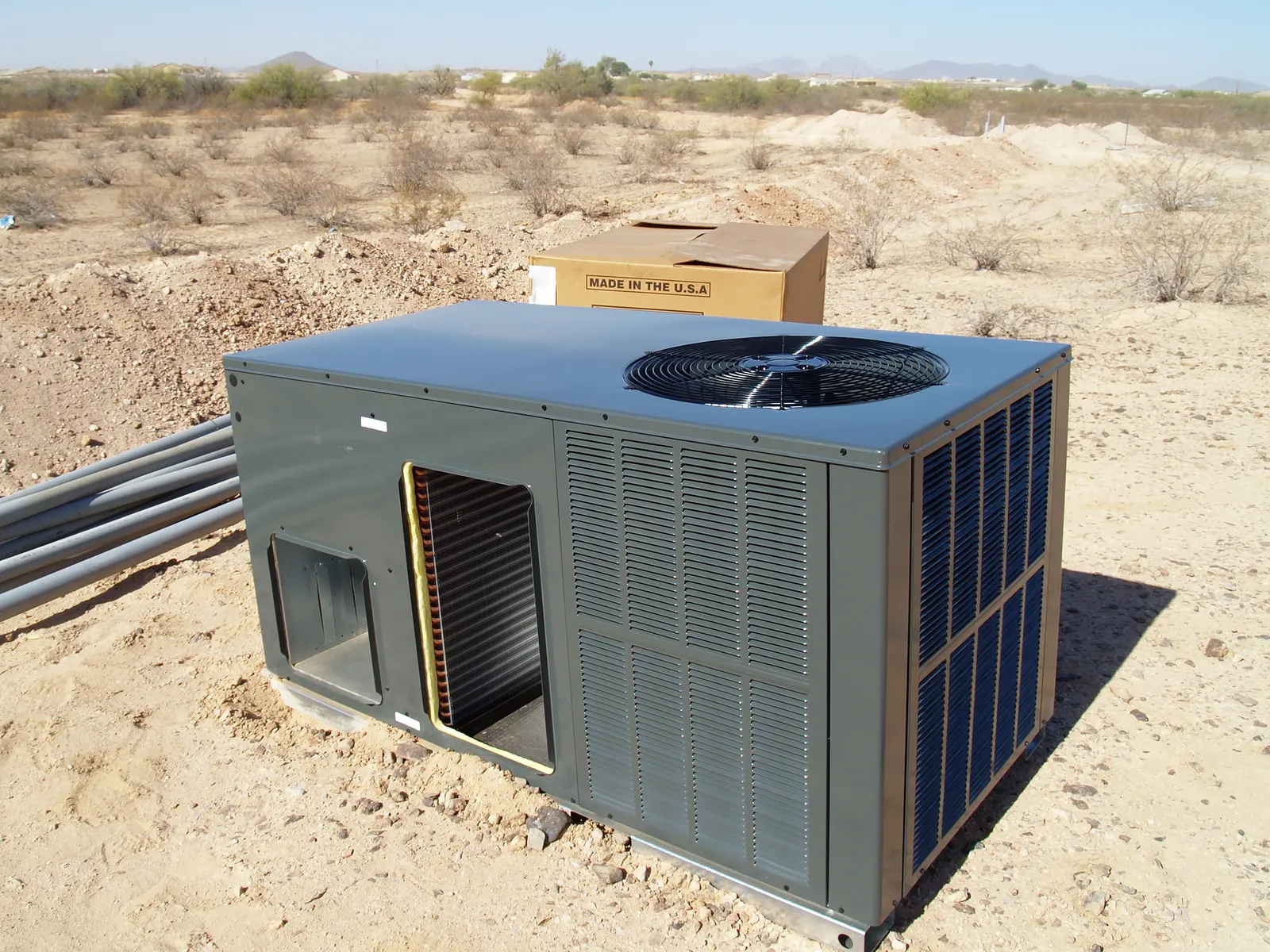 Newly installed HVAC unit with tidy ductwork in a basement